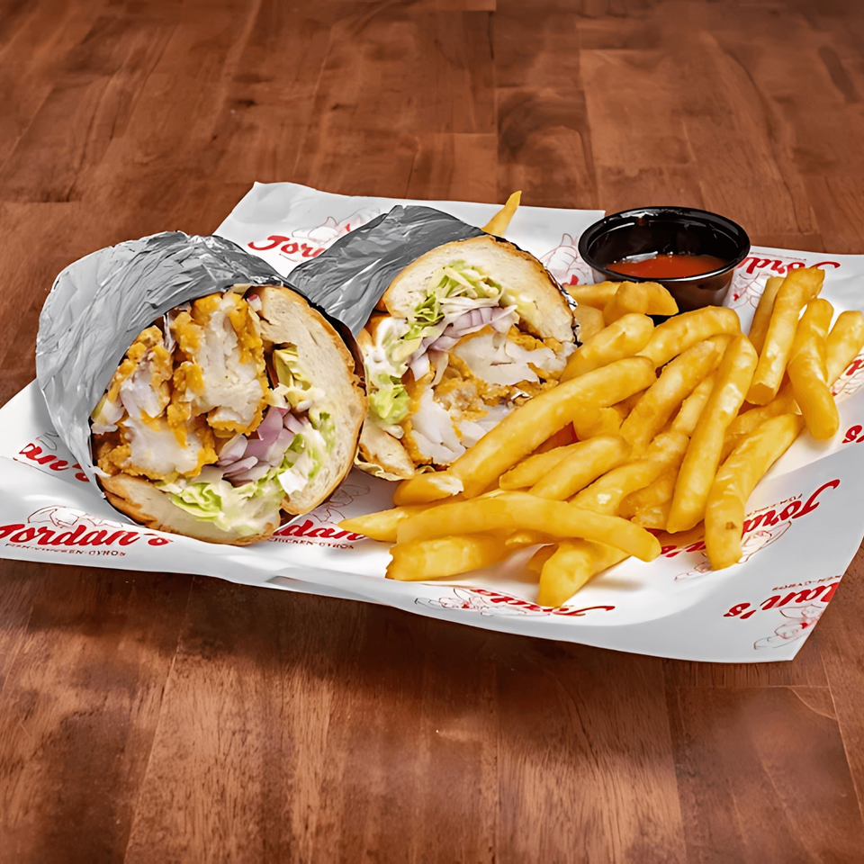 Jordan's Fish and Chicken fried fish sandwich, fries, and sauce on branded paper.